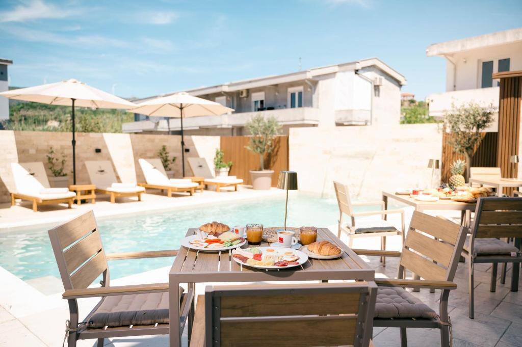 Breakfast served at a poolside table at Boutique Hotel Zara